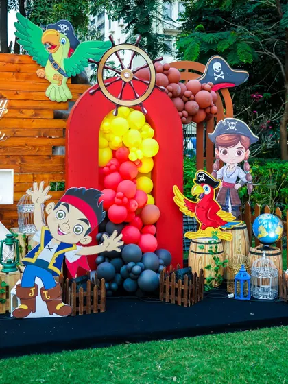 A pirate-themed photo area with character cutouts, a ship's wheel, and treasure barrels.