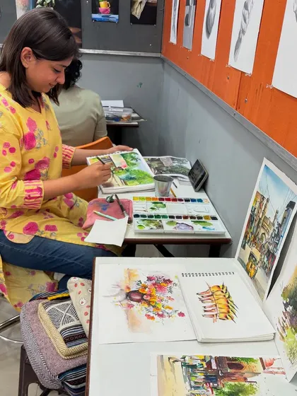 A student's workspace filled with art supplies and practice sheets, showcasing the creative energy of the workshop.