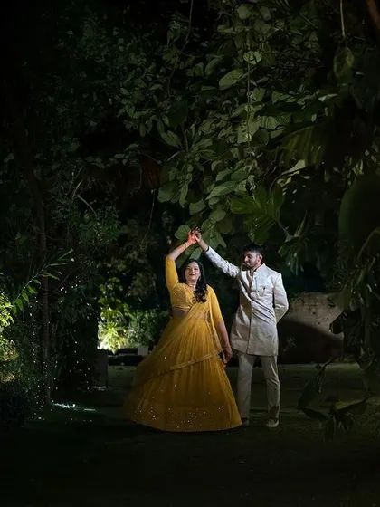A playful dance in a garden at night. I used off-camera flash to illuminate the couple, creating a dramatic and joyful portrait that captures the fun of their celebration.