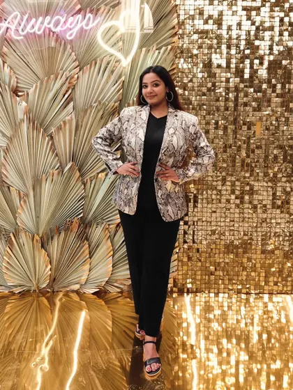 Dressed for a glamorous cocktail night. My style adapts to the theme of the event, and for this evening, a chic snakeskin blazer against a glittering gold backdrop set the perfect party tone.