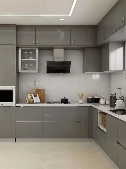 This L-shaped kitchen features a monolithic look with glossy grey cabinets throughout. The integrated microwave and white countertop keep the design clean and cohesive.