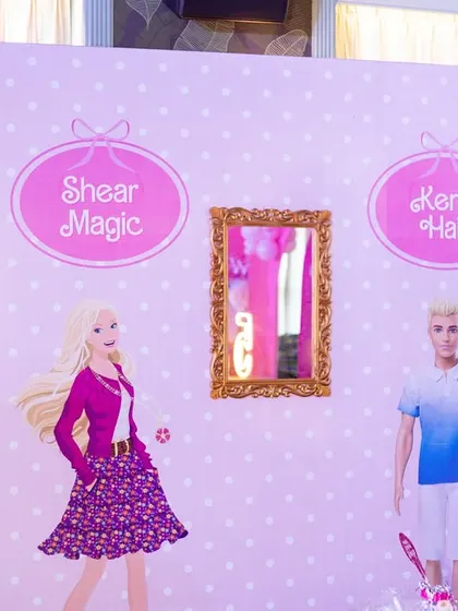 A fun photo opportunity station, "Shear Magic" and "Ken's Hair," adding an interactive and humorous touch to the Barbie theme.