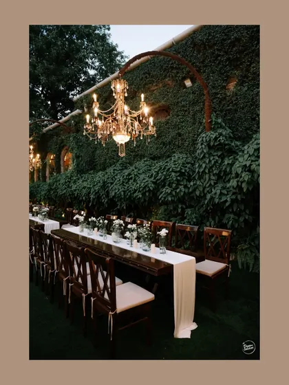 A detail shot of the elegant reception decor, featuring a long table setting under a beautiful chandelier.