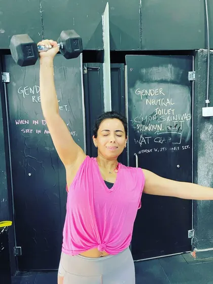 This is the face of determination. Pushing through the final reps of a single arm dumbbell press, building unilateral strength and stability.
