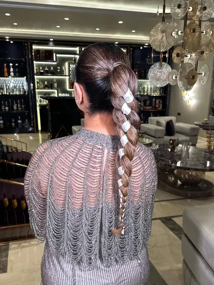 A sleek and modern braid using a Dior ribbon woven through it. This technique is perfect for creating a chic, branded look.