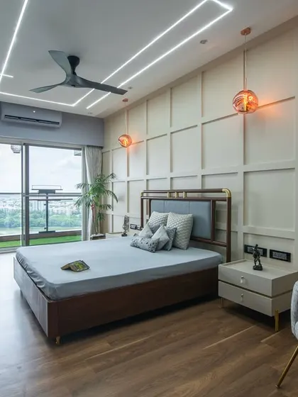 A wide shot capturing the serene and structured ambiance of the bedroom. The combination of soft blue-greys, warm wood, and clean lines creates a space that is perfect for rest and relaxation.