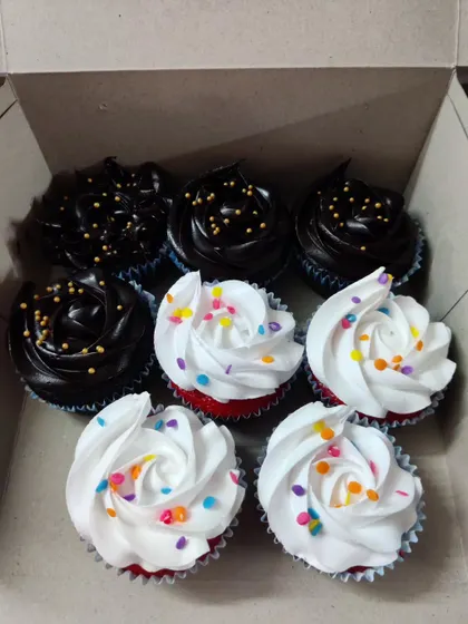 A classic combination box of my cupcakes. This one includes rich chocolate cupcakes with chocolate frosting and gold sprinkles, alongside vibrant red velvet cupcakes with white cream cheese frosting and rainbow sprinkles.