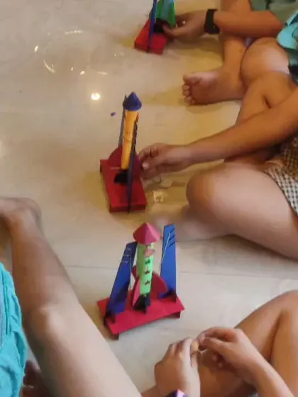 A close-up view of the rocket assembly process, showing how kids connect the different components of the launcher system.