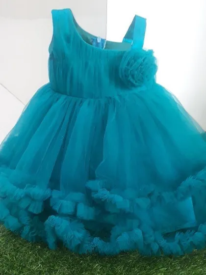 A simple and sweet blue frock with a double-layered frill hem and a flower detail.