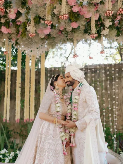 A duplicate of image 19, showing Sid and Kanika's tender kiss under the mandap. This moment is a perfect representation of love during the ceremony.