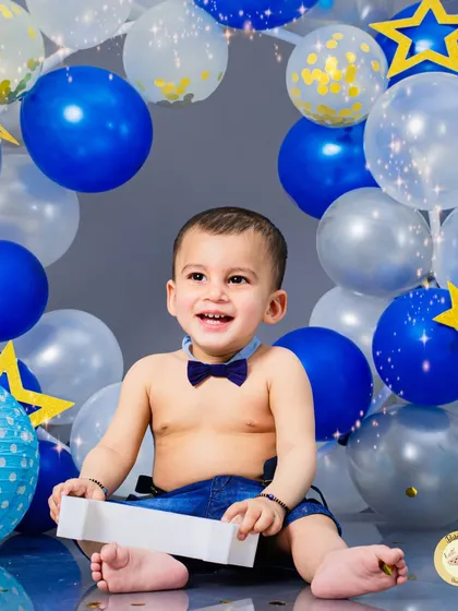 A bright and happy smile from a first birthday boy. Our studio lighting and simple backgrounds ensure that your child is the star of every photo.