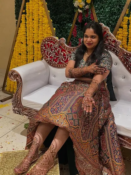 A full-length shot of the bride Madhuri, looking beautiful and relaxed with her complete bridal mehendi.