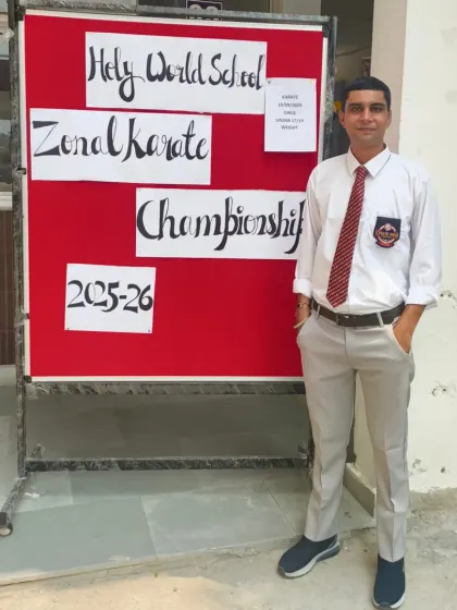 At the Zonal Karate Championship hosted at Holy World School. I am there to coach and support my students.