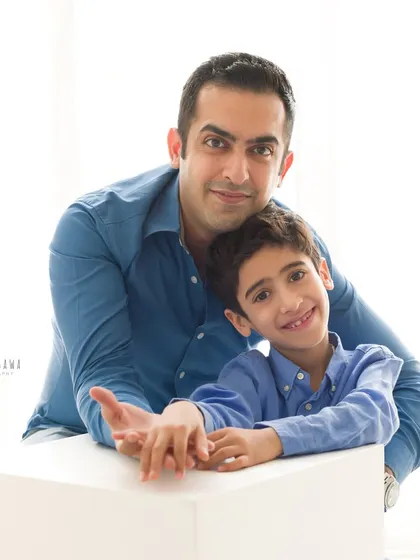 A classic father and son portrait taken during a family maternity session. Their matching blue shirts and warm smiles create a timeless image of their bond.