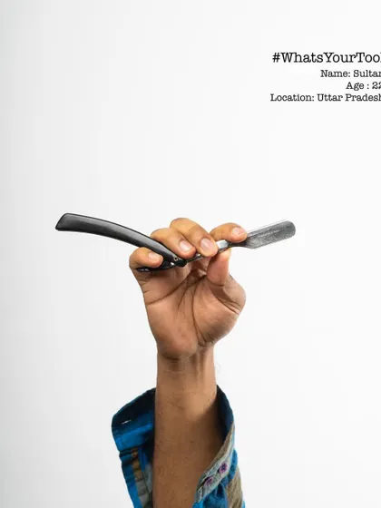 This is Sultan, a 22-year-old barber, holding his razor for the "What's Your Tool" series. The project aimed to create appreciation for the tools that enable us to earn our livelihood.