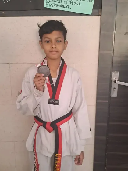 Our student with his bronze medal in the under 27kg category at the Delhi State Championship.