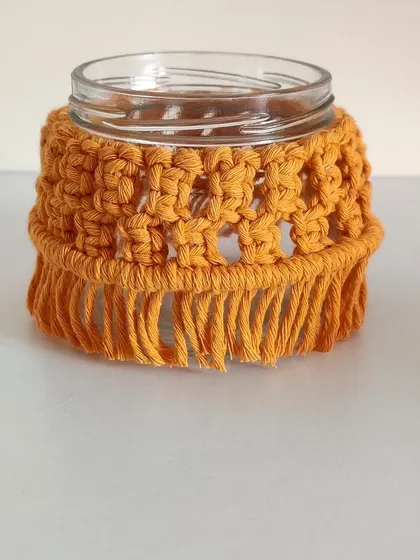 This mustard yellow macrame jar has a beautiful, open-knot pattern.