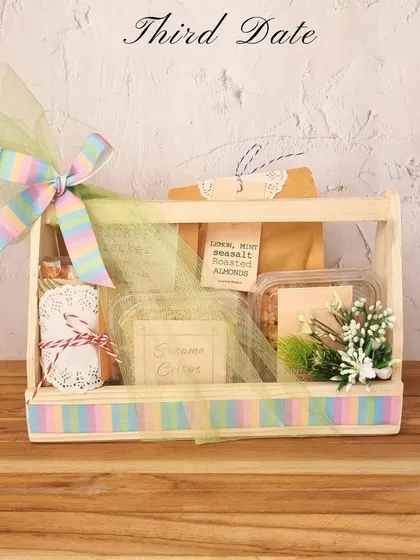 Third date? It's hamper time! This curated hamper with a rainbow ribbon is filled with their favourite snacks to show you've been paying attention.