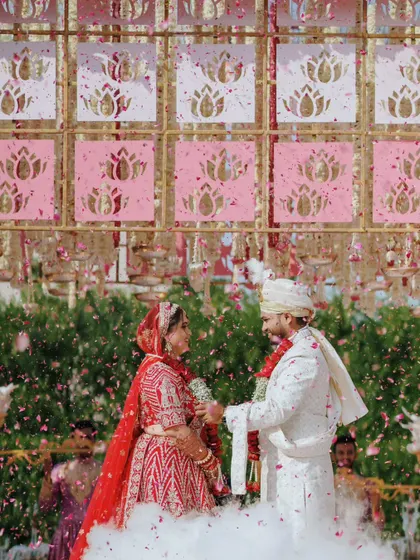 The couple exchanges garlands during the Varmaala ceremony, a classic moment captured with a modern, celebratory feel.