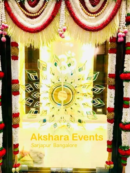 A close-up of a pooja room door decorated with traditional flower garlands. The intricate design and fresh flowers create a sacred and beautiful space for your prayers.