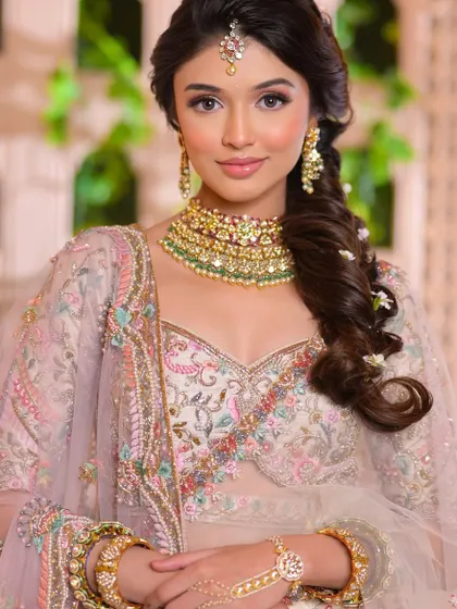 A lovely, candid shot that shows the natural feel of the makeup and the intricate embroidery of the outfit.