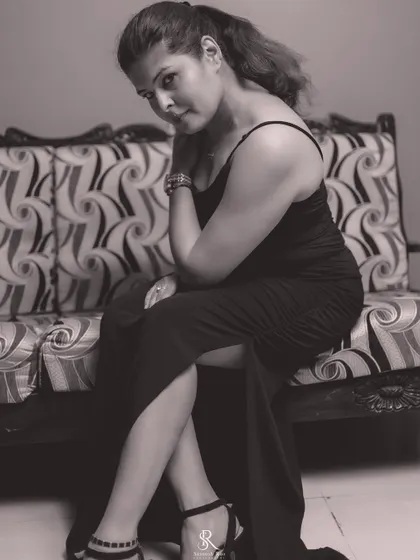 True confidence means you have no reason to hate. A powerful pose in a simple black gown, showcasing timeless style.