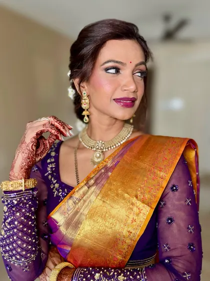 A candid moment capturing the bride's radiant smile and flawless makeup. The look is both traditional and effortlessly beautiful.