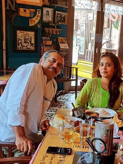 Enjoying a meal during a break at the Sodabottleopenerwala pop-up. It is important to find moments of peace and connection even during busy events.