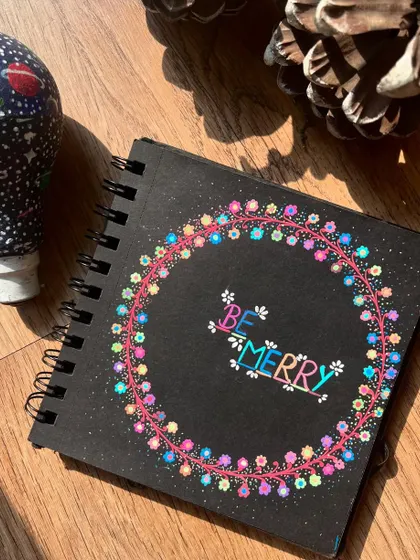 The "Be Merry" doodle next to a painted light bulb, ready for Christmas.