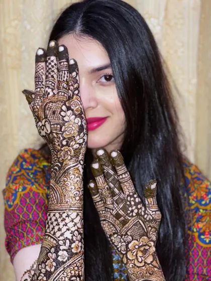 This beautiful bride is ready for her big day. Her smile and the intricate henna design make for a perfect picture.