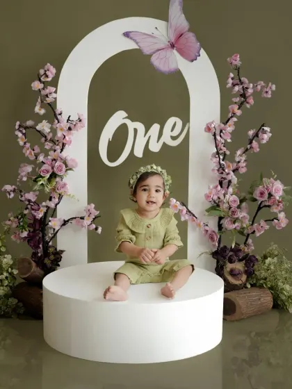 A happy smile from the birthday girl in our butterfly-themed setup. We use various props and levels to create a variety of beautiful shots within a single session.