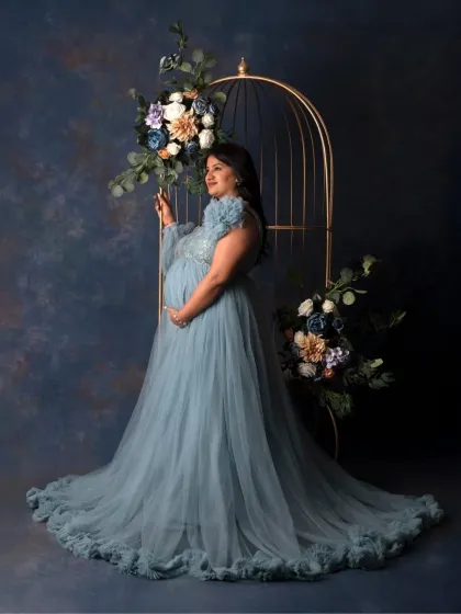 For the mama who wants to feel like a queen. In my studio, we create these elegant, glamorous portraits with flowing gowns and artistic setups like this floral cage, celebrating your strength and beauty in this powerful chapter.