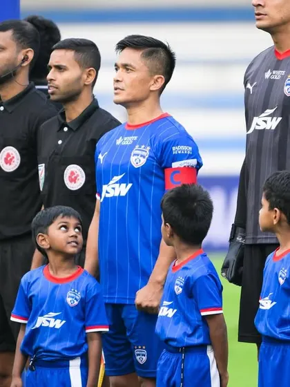 Inspiring the next generation. A young player looks up in awe at captain Sunil Chhetri during the pre-match lineup.