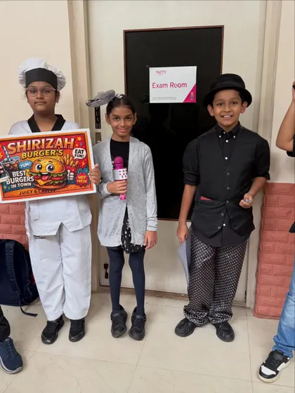 Ready and waiting outside the exam room. The props and costumes are all set for their Group Drama performance. This moment is the culmination of weeks of hard work, collaboration, and creative energy.