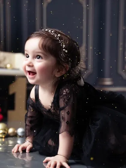 A joyful, candid moment of the birthday girl crawling and exploring the set during her photoshoot.