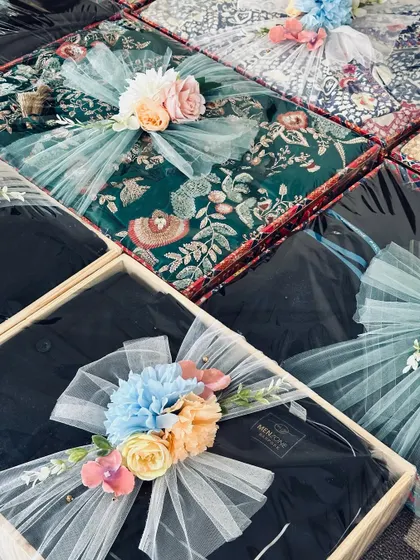 More baby shower gifts, including outfits for the baby and parents, all coordinated with a lovely floral and tulle wrapping.