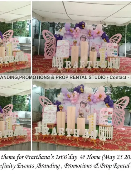 This outdoor butterfly theme for a first birthday at home is simply stunning. The setup uses a tented space, with cylinder tables, large butterfly wing props, and a beautiful balloon garland in shades of pink, purple, and white.