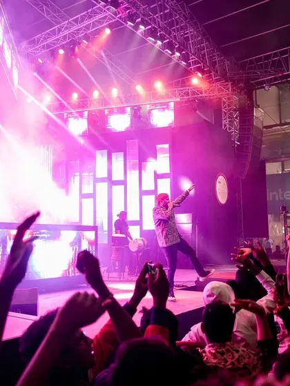 The crowd with their hands up, capturing the energy of our DJ and percussion set.