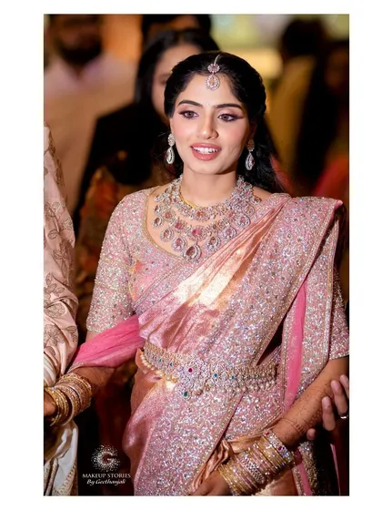 Ashitha looking radiant as she walks through her reception. The makeup is designed to be photo ready from all angles, ensuring she looks her best throughout the grand event.