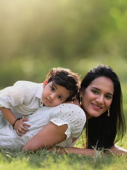 A quiet, tender moment between mother and son. Lying in the soft grass with beautiful backlighting, this portrait captures the peaceful and loving connection they share.