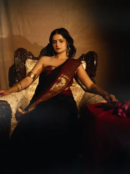 A regal, seated portrait that exudes power and grace. The lighting and composition are inspired by royal paintings.