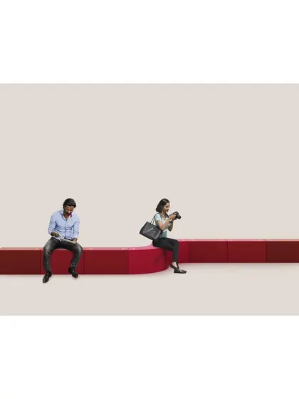 The LOKI modular bench demonstrates our belief in playful, adaptable design. Here, a series of straight and curved modules are combined to create a unique seating arrangement in a public space, showing how furniture can be both functional and interactive.