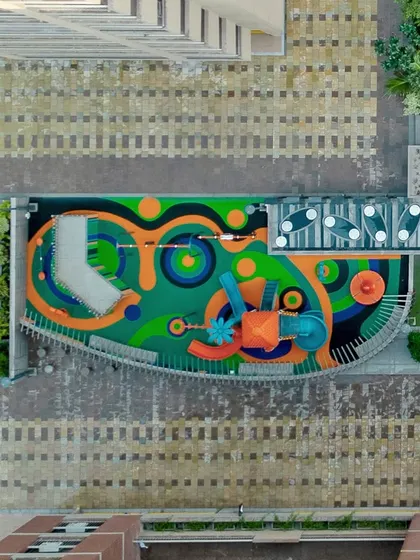 We believe community spaces should inspire joy. This aerial shot showcases the vibrant, custom-designed playground at PIXELSCAPES, where colorful, safe flooring and imaginative equipment create a hub of activity and fun for the community's youngest residents.