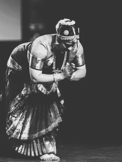 A black and white photo of me in a moment of reverence on stage. Dance is a form of prayer.
