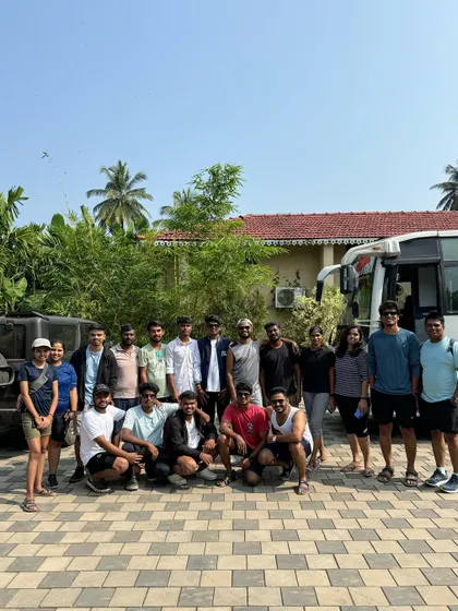 The team posing in front of the bus, ready for their Dandeli adventure.