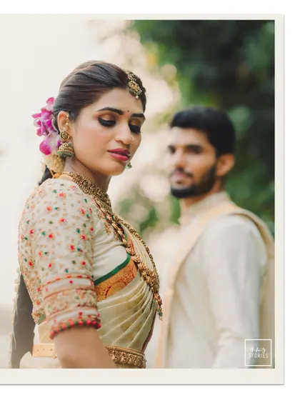 An artistic portrait with the bride in focus and the groom softly blurred in the background, creating a sense of depth and story.