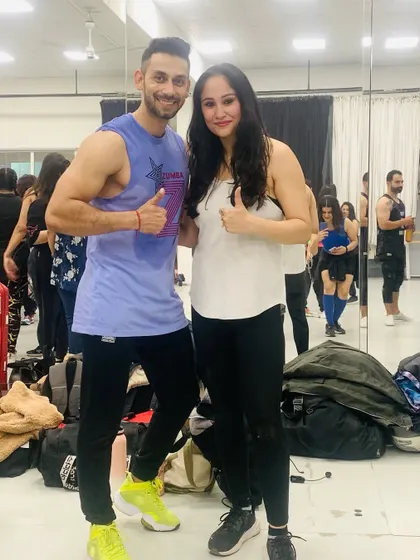 Posing with a fellow Zumba instructor. The fitness community is all about supporting and inspiring each other.