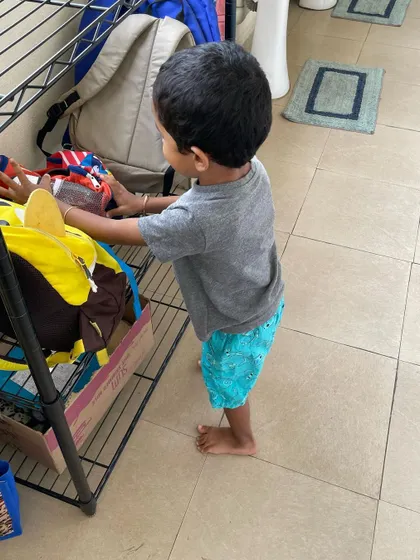 A child learns to manage their belongings, from taking off their shoes and putting them on the rack to getting their own bag. These simple routines are the building blocks of responsibility and independence.