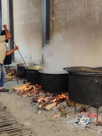This is where the magic begins. We cook our biryani and curries the traditional way, in large 'degs' over a wood fire. This slow-cooking process is key to achieving the authentic, smoky flavor that our customers love.