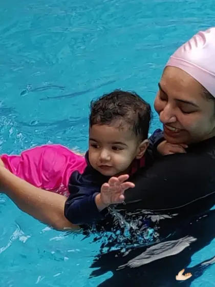 A mother supports her baby during a back float, building trust with every gentle movement.